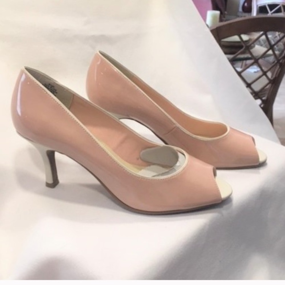 Peep toe pumps. Nude patent shoe and a white heel.